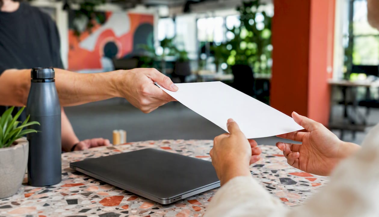 Hands handing over USB drive in negotiation
