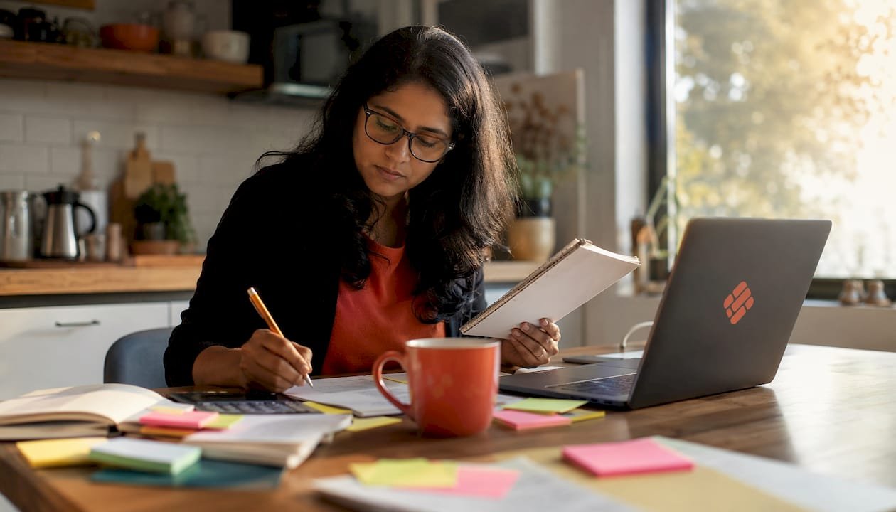 Freelancer reviewing project cost inputs at a desk