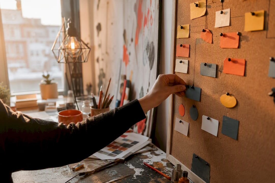 Hand placing project task tokens in creative workspace